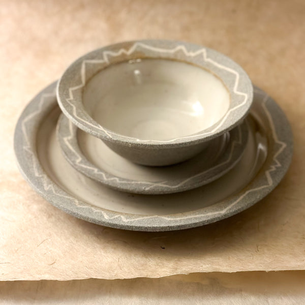 three piece handmade ceramic dinnerware set. bowl, small plate and large plate. grey and white dinnerware