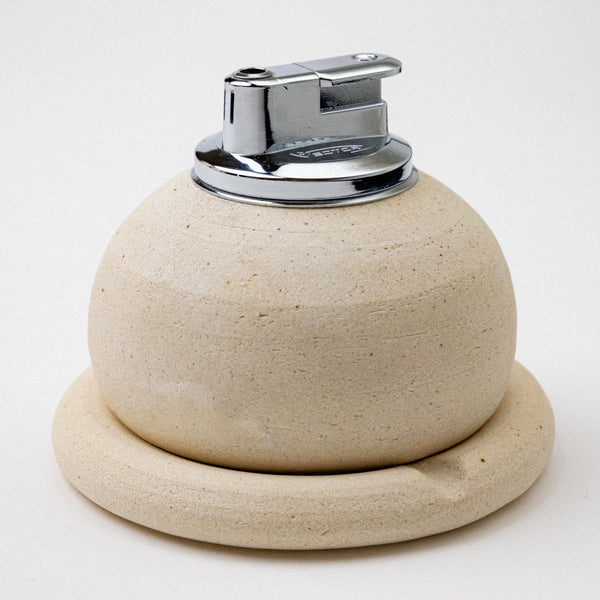 creme ashtray with table lighter. handmade ceramic pebble table lighter in satin black. maison ko x olivia snow ceramics