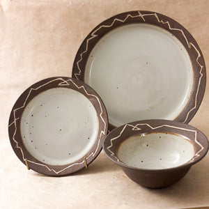 three piece handmade ceramic dinnerware set. bowl, small plate and large plate. dark brown and white dinnerware