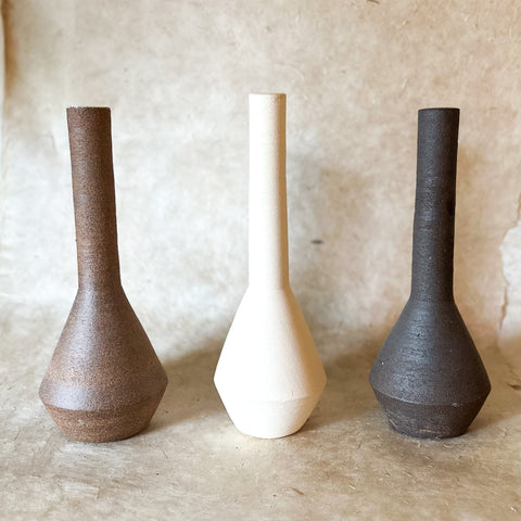 long neck vase in three colors; brown, white and dark brown 