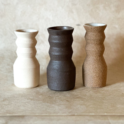 small angled vase in three colors; white, dark brown and brown