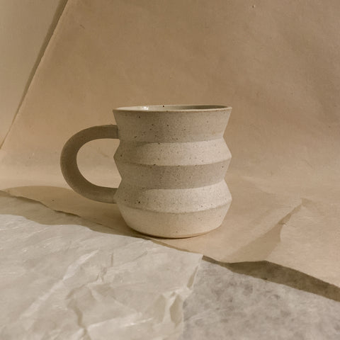 cream handmade cappuccine mug. angled.